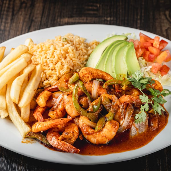 Mexican shrimp fajitas with bell peppers and onions, served with rice, fries, avocado, and salsa.